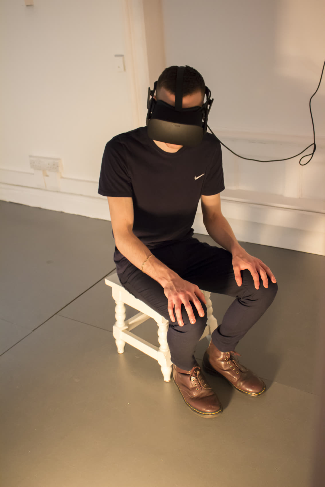 Seated on the stool from the painting, inside the work