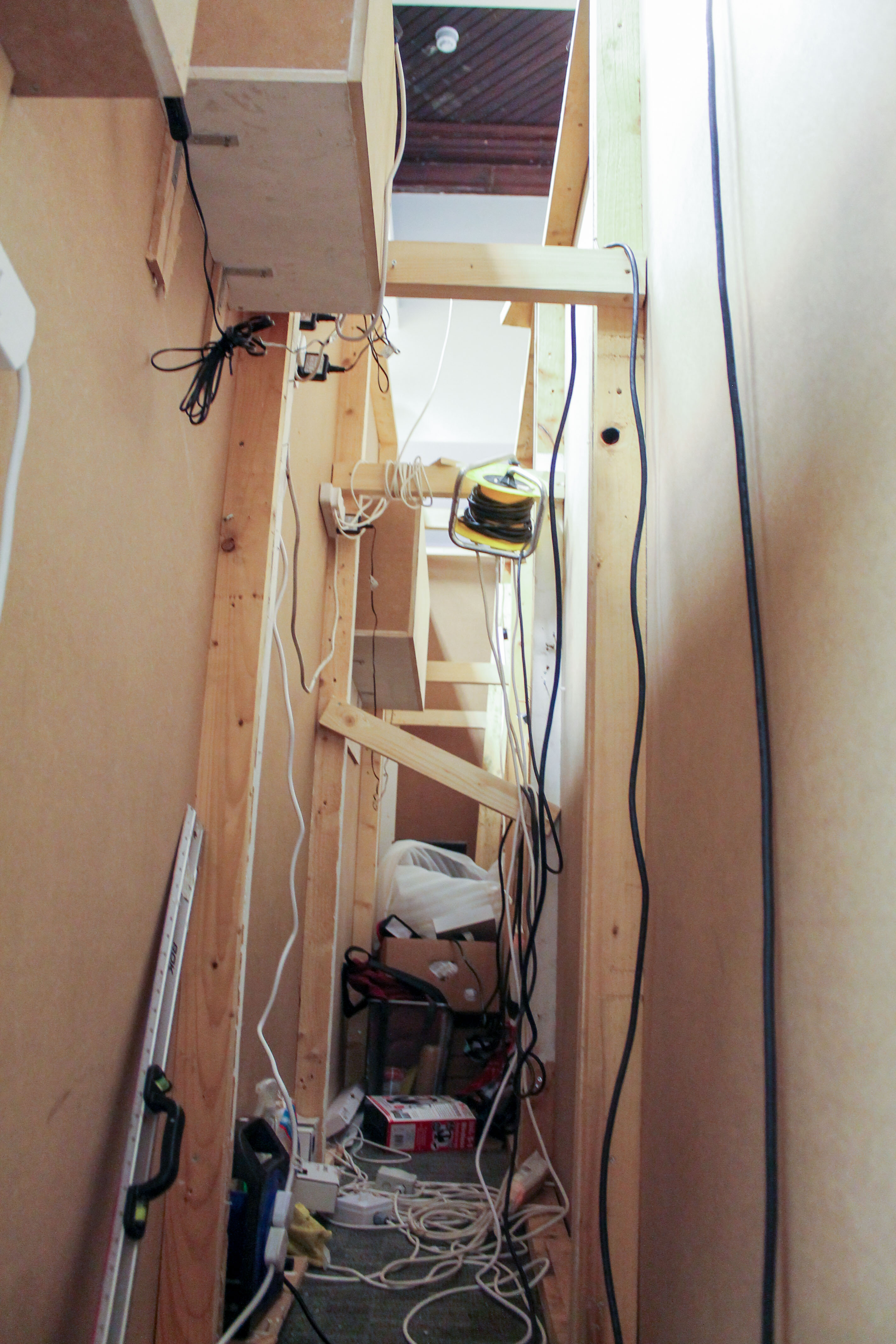 Construction — building the display walls; wiring and timber frame behind the panelling