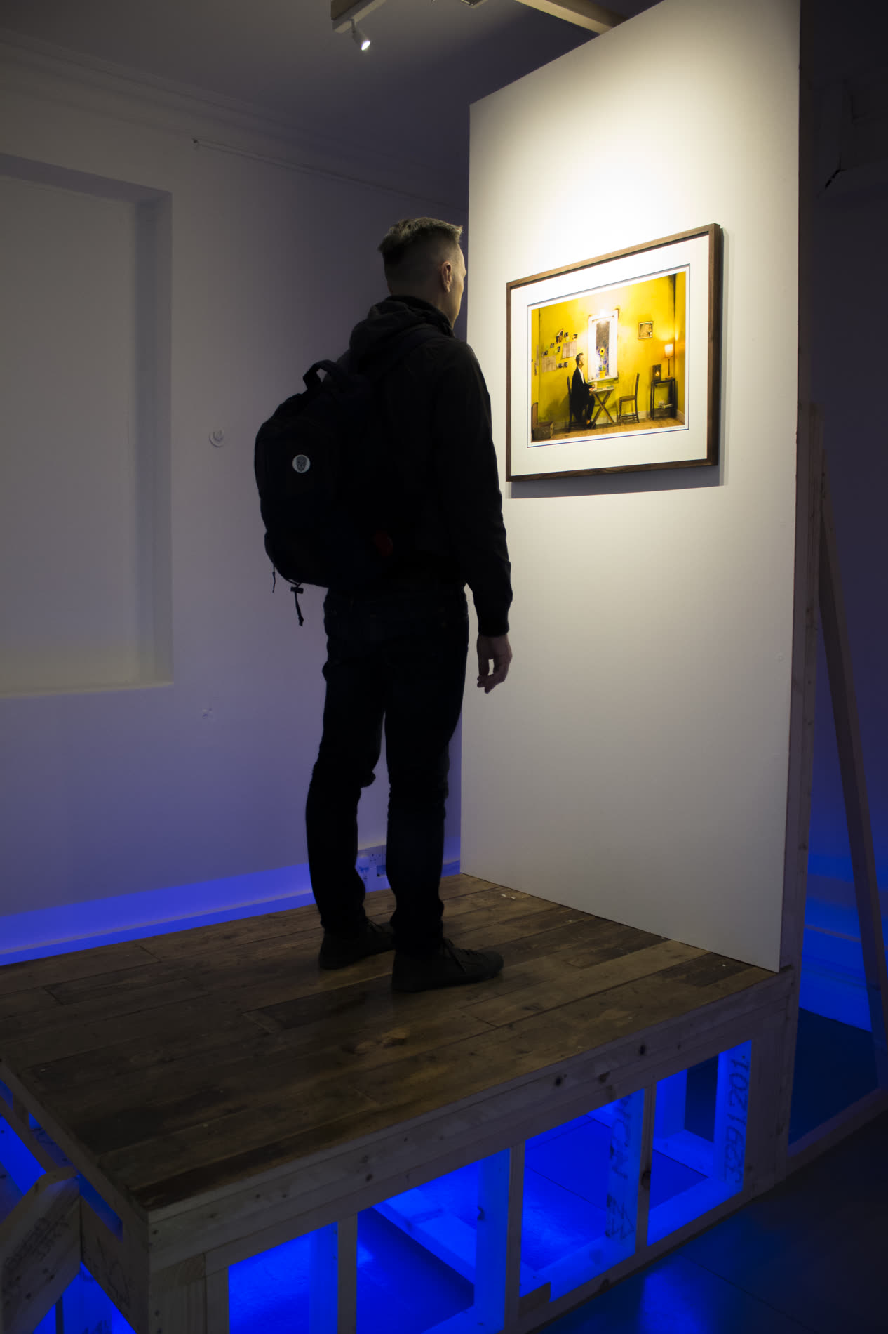 A visitor steps up to the framed photograph